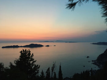 Scenic view of lake against sky during sunset