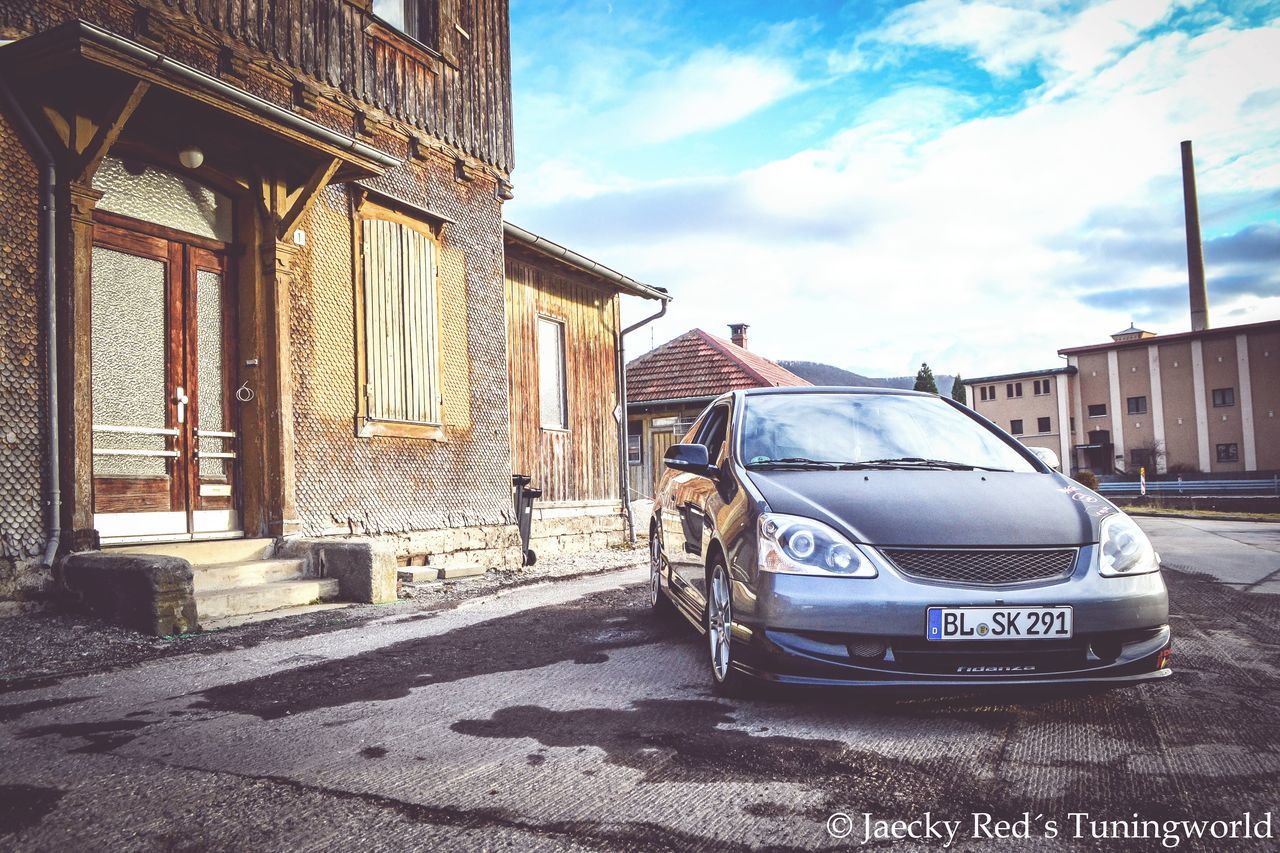 building exterior, architecture, built structure, sky, city, transportation, car, land vehicle, street, building, mode of transport, travel, travel destinations, cloud - sky, day, outdoors, history, residential building, sunlight, residential structure