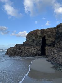 Rock formations by sea against sky