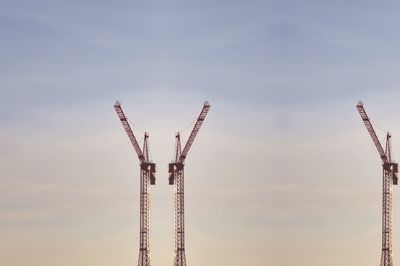 Low angle view of crane against sky at sunset