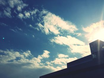 Low angle view of building against cloudy sky