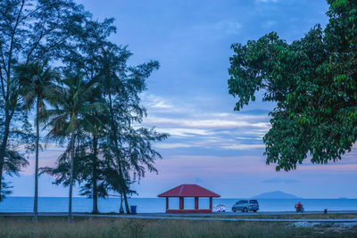 Scenic view of sea by building against sky