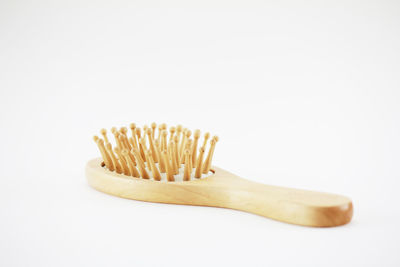 Wooden handle comb on white background