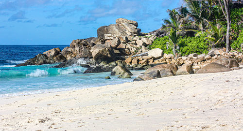 Rocks on beach against sky