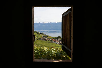 Scenic view of mountains and lake seen through window