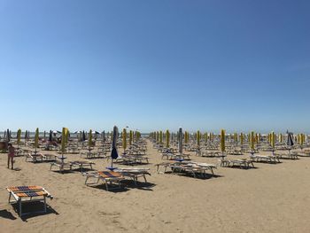 Scenic view of beach against clear blue sky