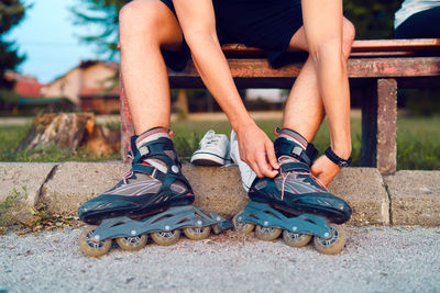 Low section of man wearing inline skates