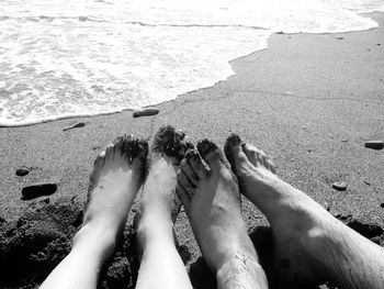 Low section of people relaxing on beach