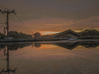 Reflection of bridge against sky during sunset