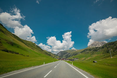 Road amidst mountains against sky