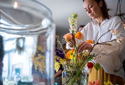 Florist girl makes a bouquet at am master class in flowers