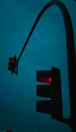 Low angle view of traffic signal against sky