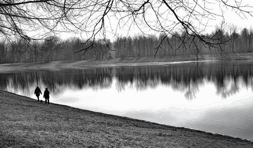 Friends walking by lake