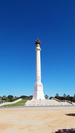 Low angle view of tower against blue sky during sunny day