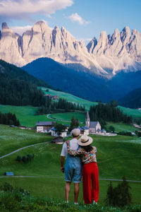 Woman on field by mountains against sky