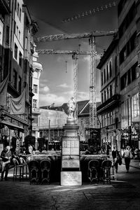 People on street against buildings in city