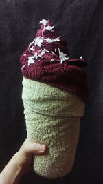 Close-up of hand holding ice cream cone