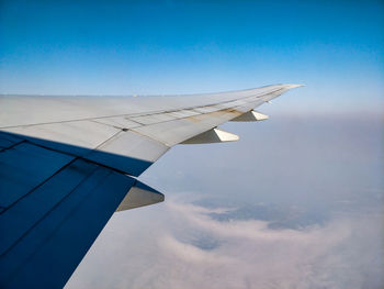 Aircraft wing against sky