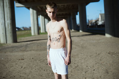 Shirtless young man outdoors