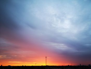 Silhouette landscape against dramatic sky during sunset