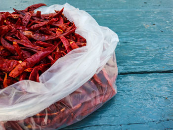 High angle view of red chili peppers in container