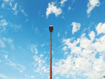 Low angle view of street light against blue sky