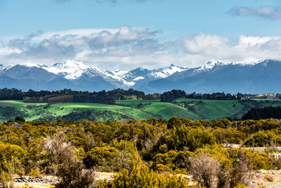 Scenic view of landscape and mountains against sky