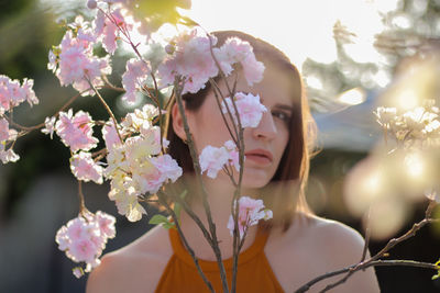Close-up of woman with pink flowers