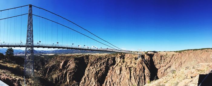Suspension bridge against clear blue sky
