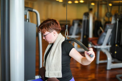 Determined woman exercising in gym