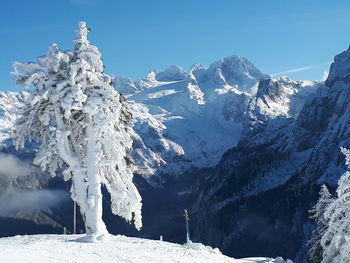 Scenic view of snowcapped mountains against clear blue sky