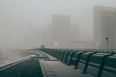 Road by buildings in city during winter