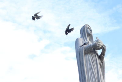 Low angle view of statue against sky