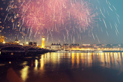 Firework display over city at night