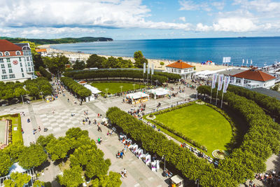 High angle view of townscape by sea against sky