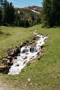 Scenic view of waterfall on field