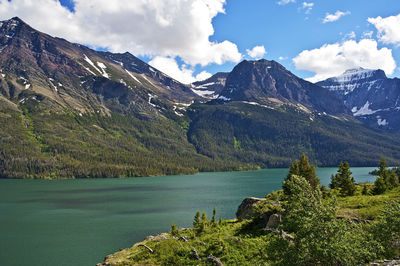 Scenic view of lake and mountains against sky