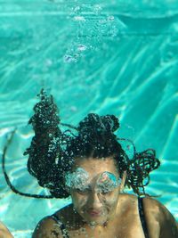 Close-up of young woman swimming in pool