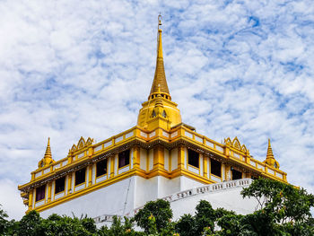 Low angle view of temple building against cloudy sky