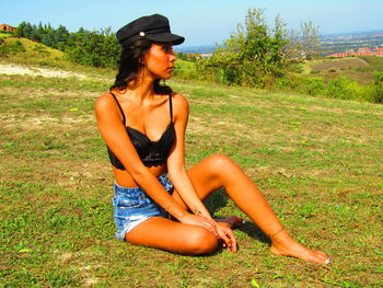 Young woman sitting on field
