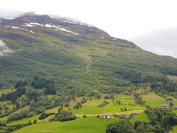 High angle view of field and mountains against sky