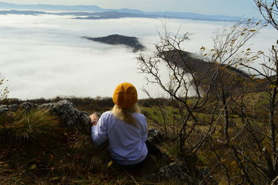 Rear view of woman standing on mountain