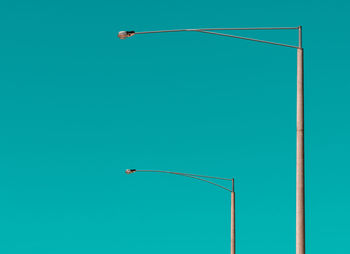 Low angle view of street light against blue sky