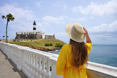 Rear view of woman looking at sea against sky