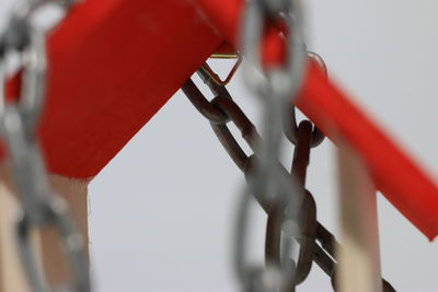 Close-up of red metal fence against wall