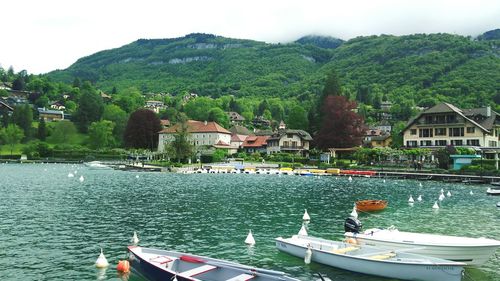 Boats in river against buildings