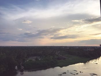 Scenic view of river against sky at sunset