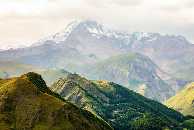 Scenic close up view of kazbek mountain and gergeti trinity church in georgia at sunrise in summer
