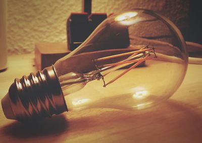 Close-up of light bulb on table