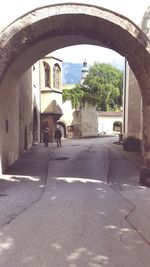 Rear view of people on street amidst buildings in city